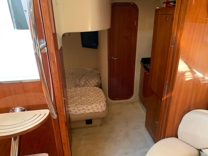 Slide: The Image of Interior cabin of 2009 Regal 4460 yacht with twin beds and wooden finishes. - 40