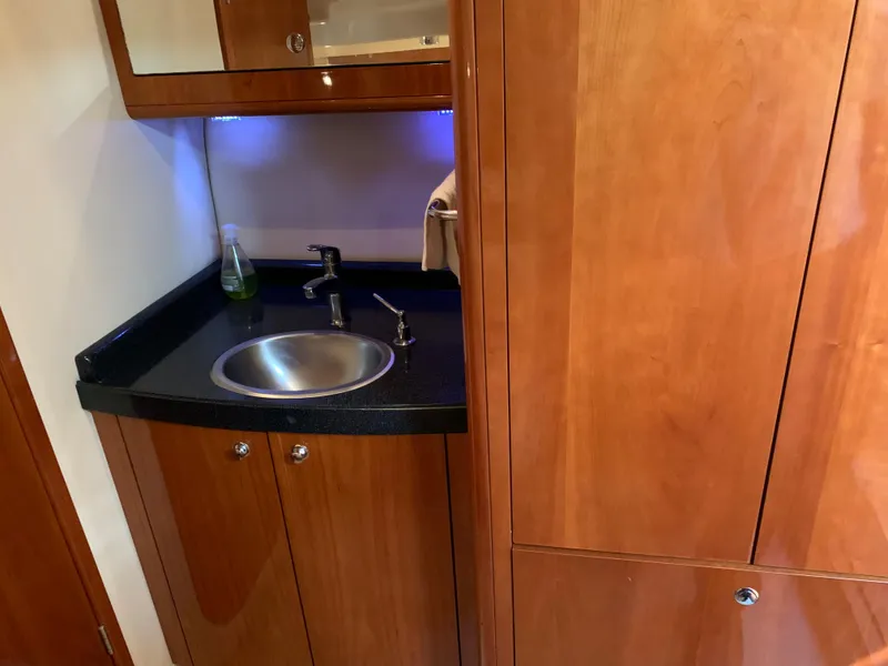 Slide: The Image of 2009 Regal 4460 yacht interior sink area with wooden cabinetry and modern fixtures. - 42