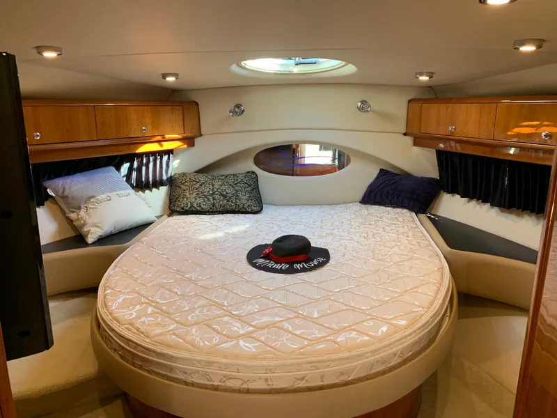 Slide: The Image of Luxurious 2009 Regal 4460 yacht bedroom with round bed and wooden cabinets. - 48