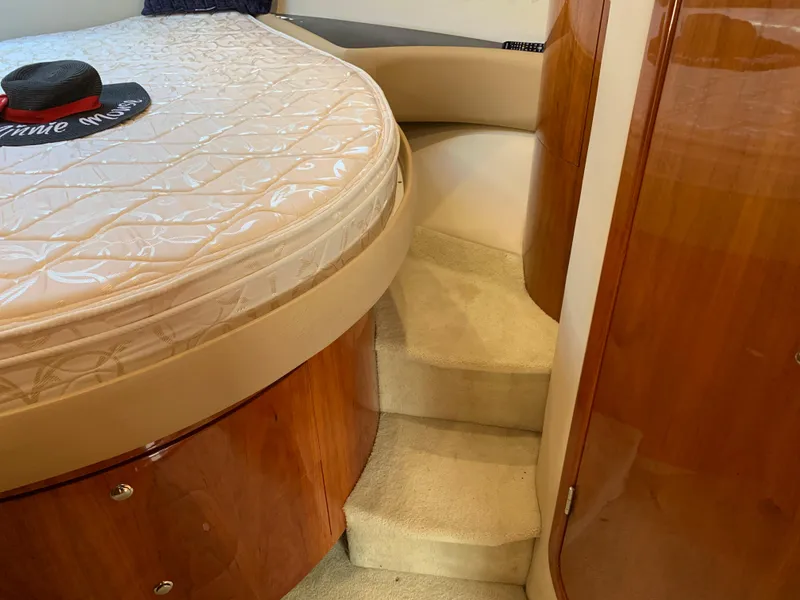 Slide: The Image of Interior of 2009 Regal 4460 yacht showing bed and carpeted stairs. - 49