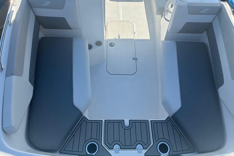 Slide: The Image of 2026 Starcraft SVX 171 OB boat interior with gray seating and storage compartments. - 10