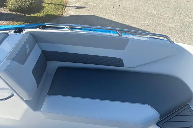 Slide: The Image of 2026 Starcraft SVX 171 OB boat interior with cushioned seating and cup holder. - 13