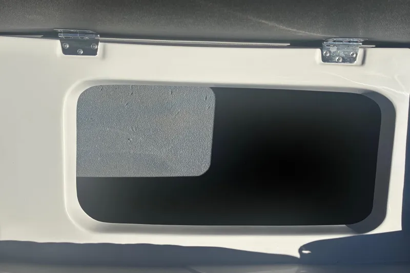 Slide: The Image of Storage compartment on a 2026 Starcraft SVX 171 OB boat, featuring metal hinges. - 3