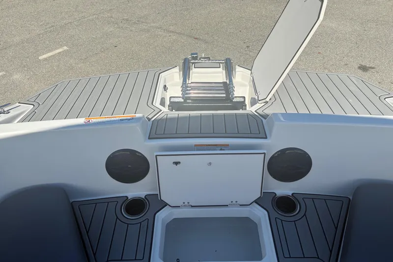 Slide: The Image of 2026 Starcraft SVX 171 OB boat interior with storage compartment and cup holders. - 6
