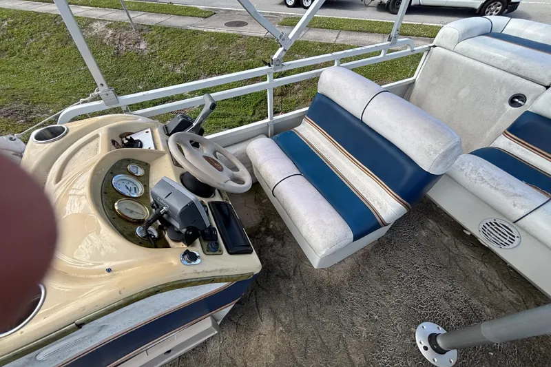 Slide: The Image of 2005 Bentley Pontoons 200 Fish interior with steering console and blue-striped seating. - 20