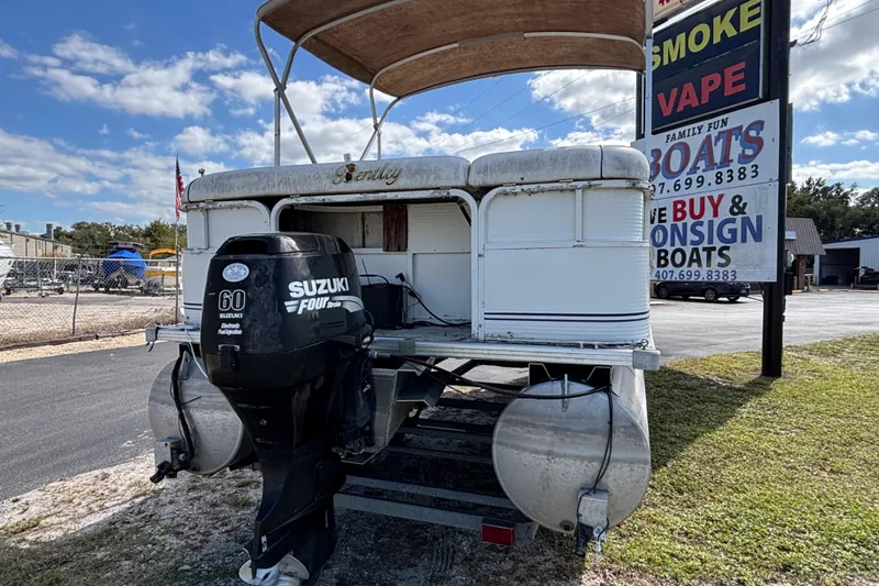 Slide: The Image of 2005 Bentley Pontoons 200 Fish with Suzuki 60 outboard motor, parked near boat dealership. - 22