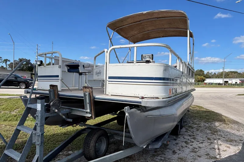 Slide: The Image of 2005 Bentley Pontoons 200 Fish on trailer under clear blue sky. - 28