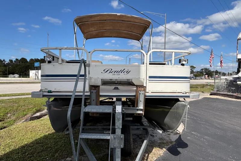 Slide: The Image of 2005 Bentley Pontoons 200 Fish boat on trailer under blue sky. - 29