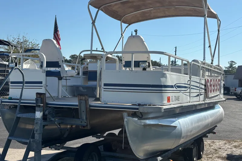 Slide: The Image of 2005 Bentley Pontoons 200 Fish boat on trailer, featuring canopy and seating. - 42