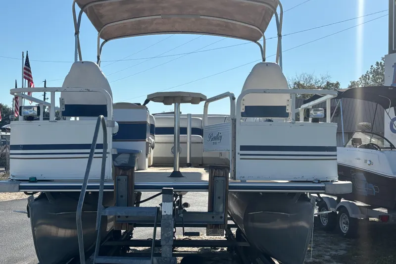 Slide: The Image of 2005 Bentley Pontoons 200 Fish on trailer, featuring dual seating and canopy. - 43