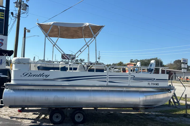 Slide: The Image of 2005 Bentley Pontoons 200 Fish boat on trailer, featuring canopy and seating. - 45