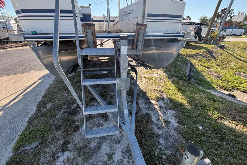 Slide: The Image of 2005 Bentley Pontoons 200 Fish on trailer, side view with metal steps. - 49