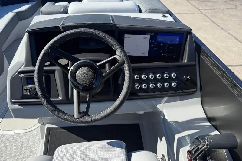 Slide: The Image of 2026 Alera M 25Q boat dashboard with steering wheel and control panel. - 10