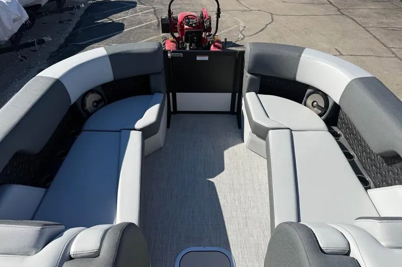 Slide: The Image of 2026 Alera M 25Q boat interior with gray seating and steering console. - 12