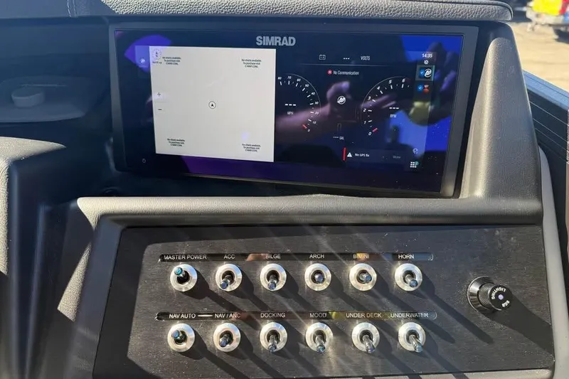 Slide: The Image of Control panel of 2026 Alera M 25Q boat with Simrad display and switches. - 14
