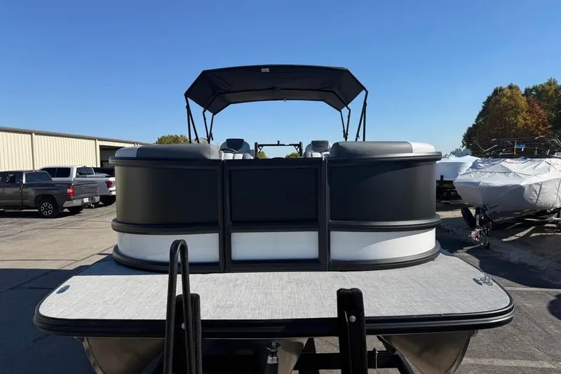 Slide: The Image of 2026 Alera M 25Q pontoon boat with canopy, parked outdoors on a sunny day. - 2