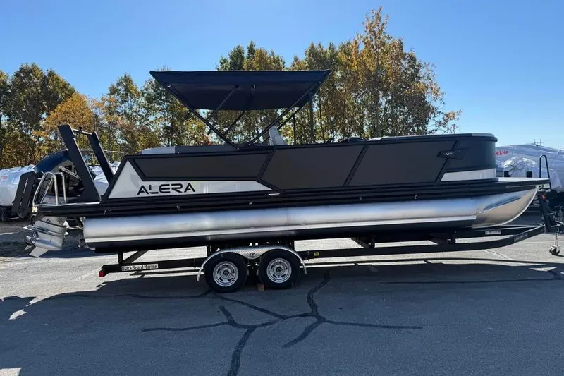 Slide: The Image of 2026 Alera M 25Q pontoon boat on trailer, parked outdoors. - 4