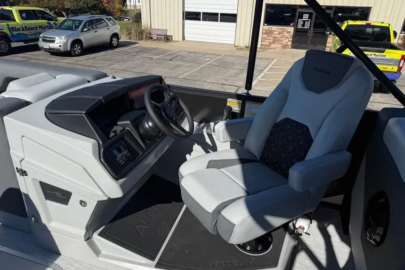 Slide: The Image of 2026 Alera M 25Q boat interior with modern steering and comfortable seating. - 9
