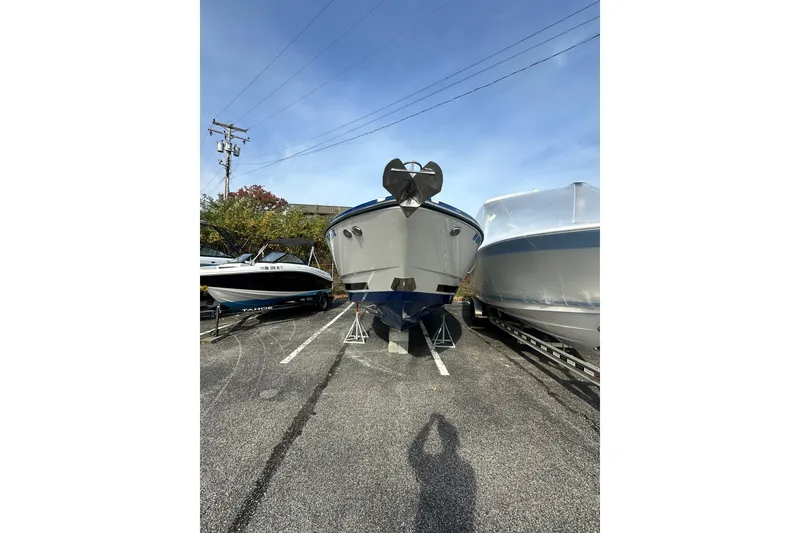 Slide: The Image of 2019 Monterey 305SS Super Sport boat on display in a parking lot. - 13