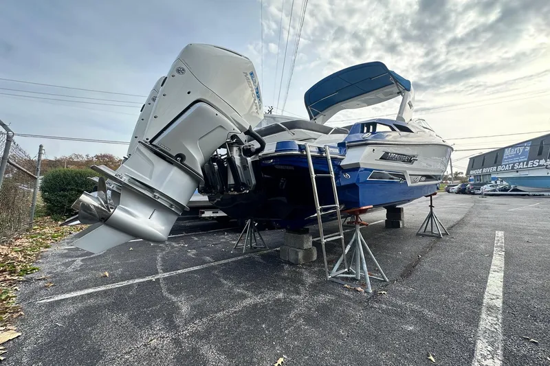 Slide: The Image of 2019 Monterey 305SS Super Sport boat on stands in a parking lot. - 14