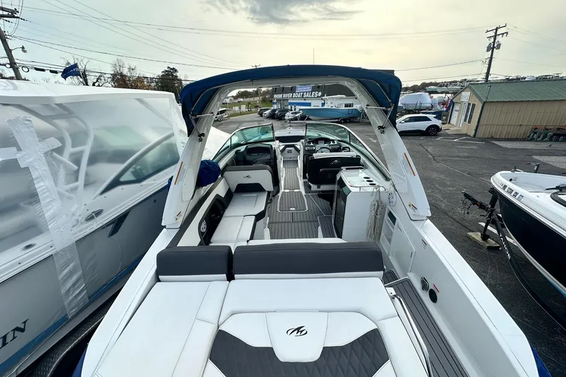 Slide: The Image of 2019 Monterey 305SS Super Sport boat with spacious seating and modern design at a sales lot. - 23