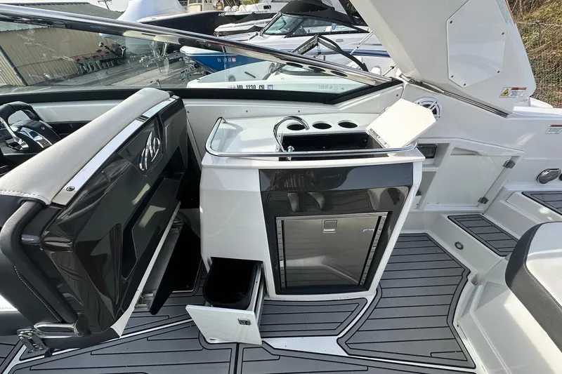 Slide: The Image of 2019 Monterey 305SS Super Sport boat interior with sleek kitchenette and modern design. - 26