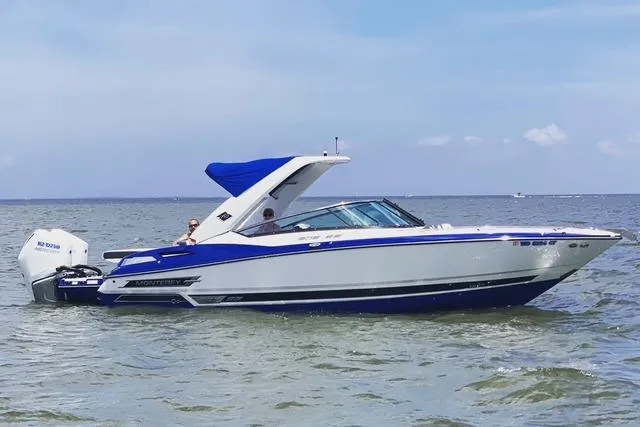 Slide: The Image of 2019 Monterey 305SS Super Sport boat docked at marina under clear blue sky. - 3