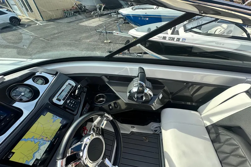 Slide: The Image of 2019 Monterey 305SS Super Sport boat cockpit with navigation system and steering wheel. - 31