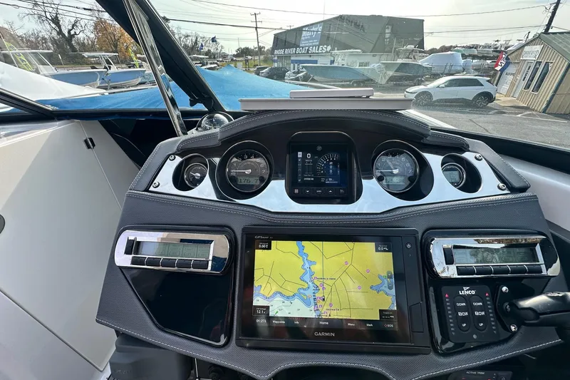 Slide: The Image of Cockpit view of 2019 Monterey 305SS Super Sport boat with navigation system and controls. - 35