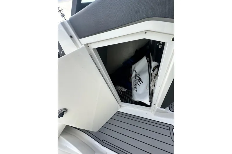 Slide: The Image of 2019 Monterey 305SS Super Sport boat with sleek design, docked outdoors. - 41