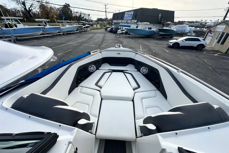 Slide: The Image of 2019 Monterey 305SS Super Sport boat with spacious seating at a boat dealership. - 45