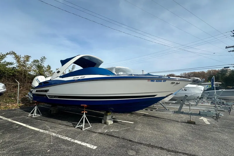 Slide: The Image of 2019 Monterey 305SS Super Sport boat on display in a parking lot. - 5