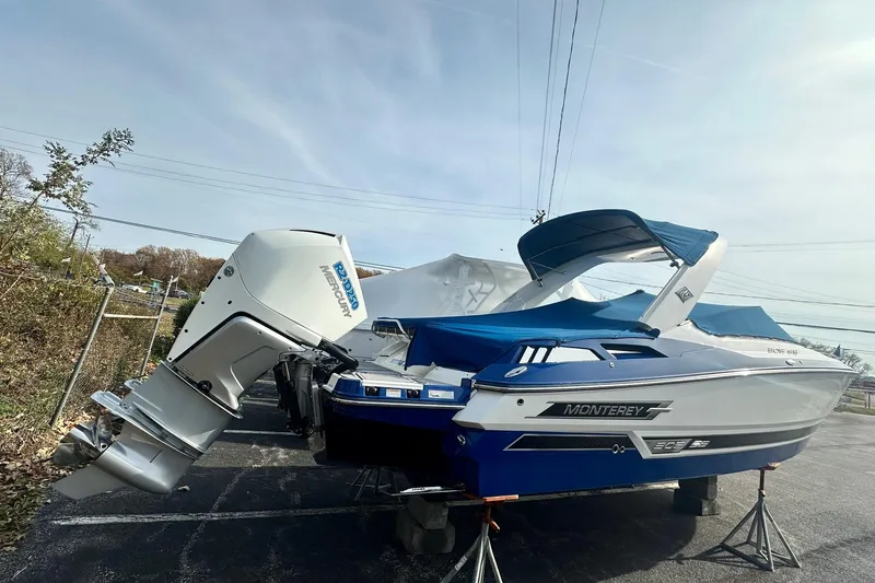 Slide: The Image of 2019 Monterey 305SS Super Sport boat with blue cover and powerful outboard motor. - 6