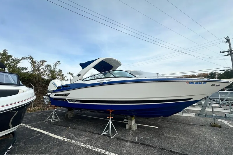 Slide: The Image of 2019 Monterey 305SS Super Sport boat on display in a parking lot. - 7