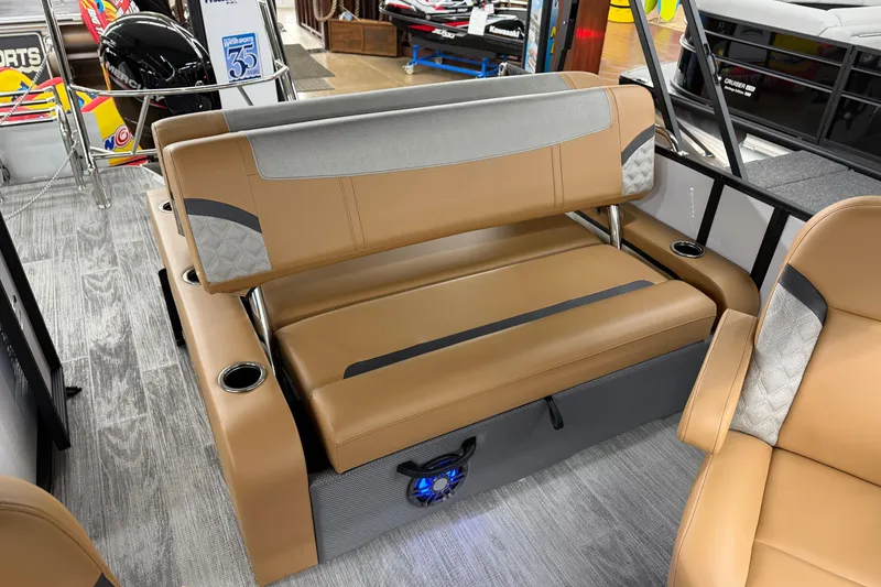 Slide: The Image of 2025 Crest Classic 220 boat interior with tan seating and cup holders. - 11