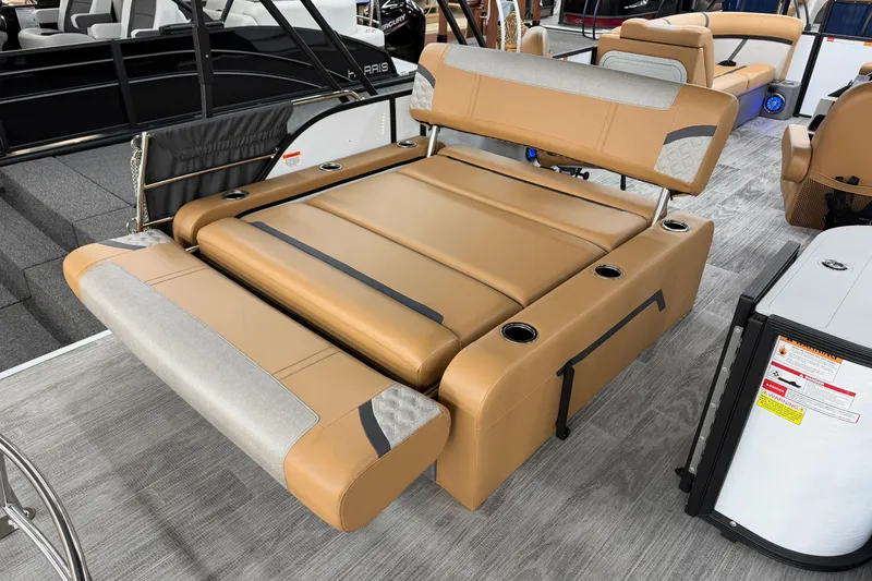 Slide: The Image of 2025 Crest Classic 220 boat interior with tan seating and cup holders. - 13
