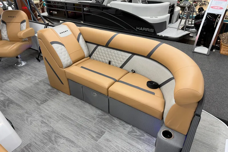 Slide: The Image of 2025 Crest Classic 220 boat interior with tan and gray seating, modern design. - 3