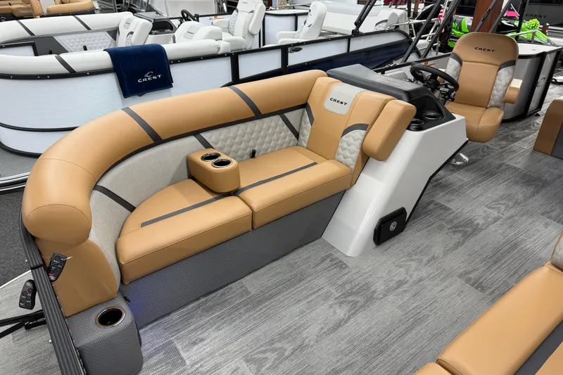 Slide: The Image of 2025 Crest Classic 220 boat interior with tan seating and modern design. - 4