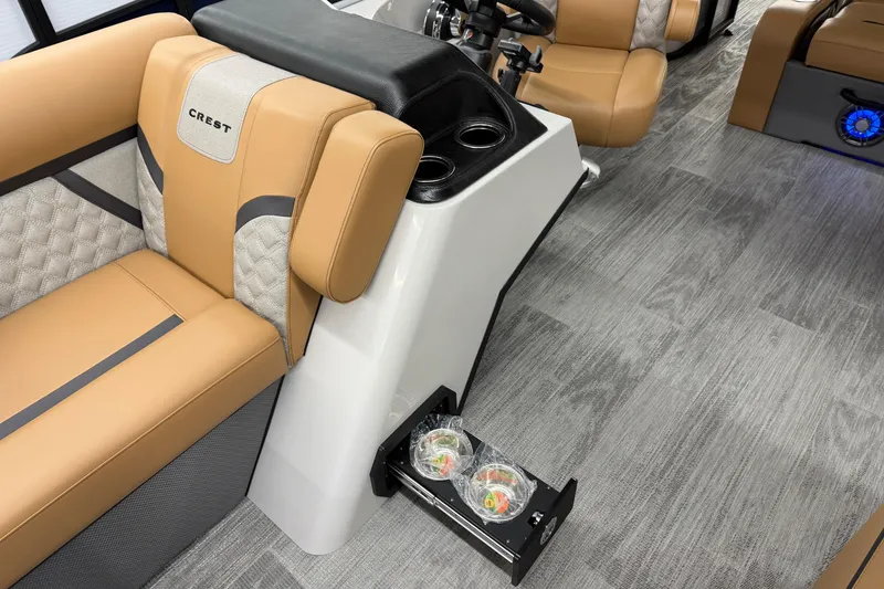 Slide: The Image of 2025 Crest Classic 220 interior with tan seating and modern console design. - 5