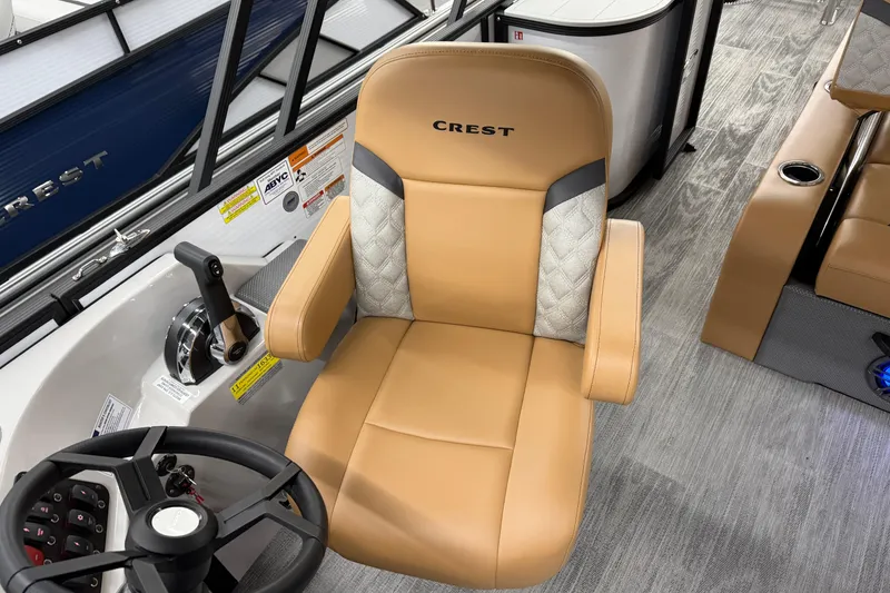 Slide: The Image of Captain's chair on 2025 Crest Classic 220 boat, featuring tan upholstery and modern controls. - 7