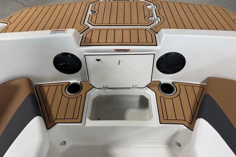 Slide: The Image of 2025 Starcraft SVX 171 OB boat interior with wood accents and storage compartments. - 5
