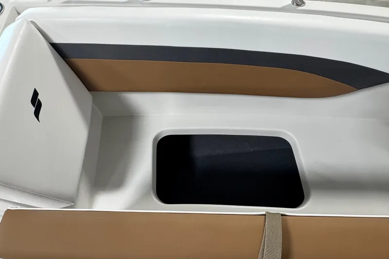 Slide: The Image of 2025 Starcraft SVX 171 OB boat interior with brown and white seating. - 8