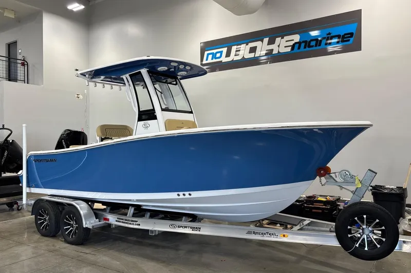 Slide: The Image of 2025 Sportsman Open 212 Center Console boat on trailer in showroom. - 2