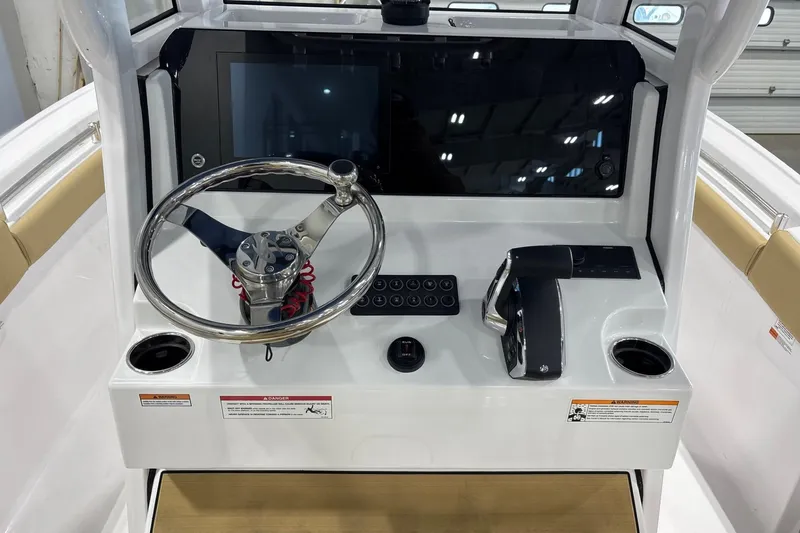 Slide: The Image of 2025 Sportsman Open 212 Center Console dashboard with steering wheel and controls. - 5