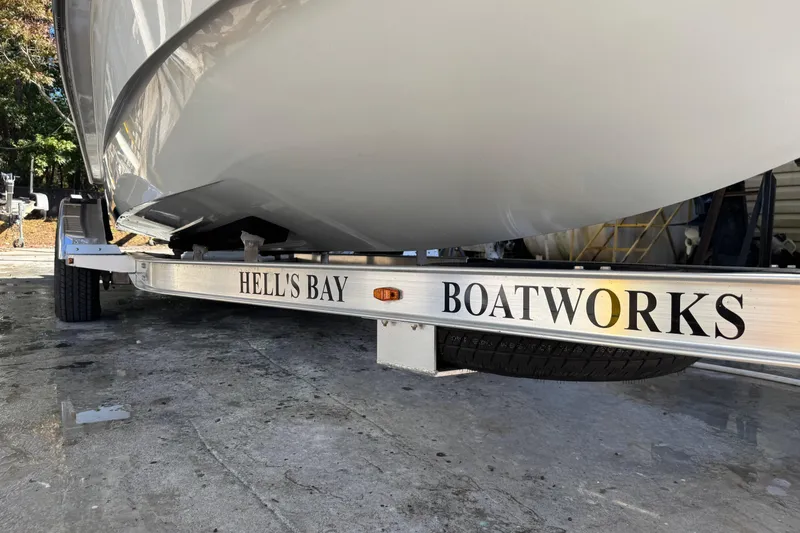 Slide: The Image of 2020 Hell's Bay Marquesa boat on trailer, showcasing "Hell's Bay Boatworks" branding. - 11