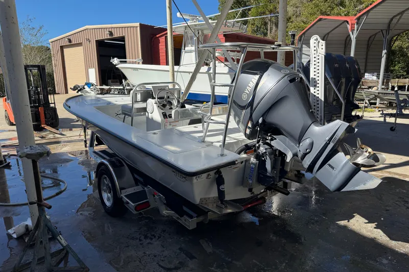 Slide: The Image of 2020 Hell's Bay Marquesa boat with Yamaha outboard motor in a workshop setting. - 14