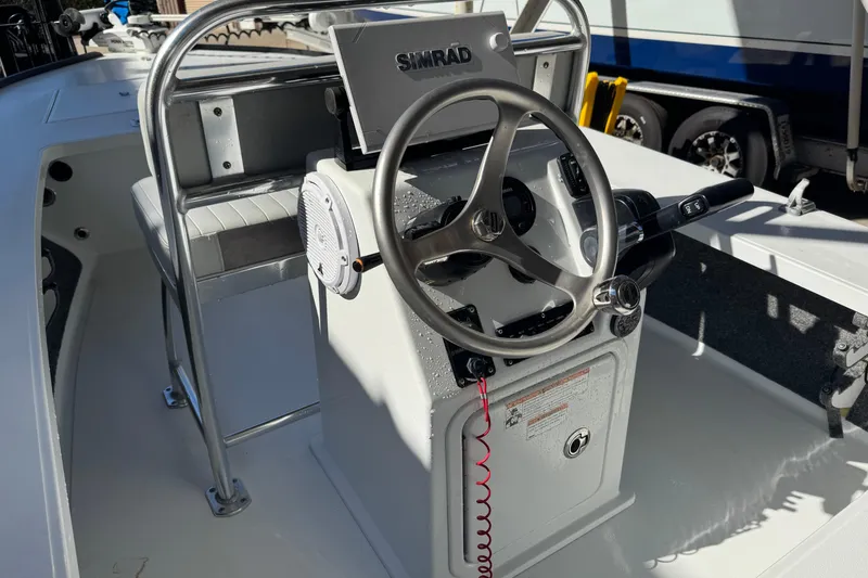 Slide: The Image of 2020 Hell's Bay Marquesa boat console with steering wheel and Simrad display. - 20