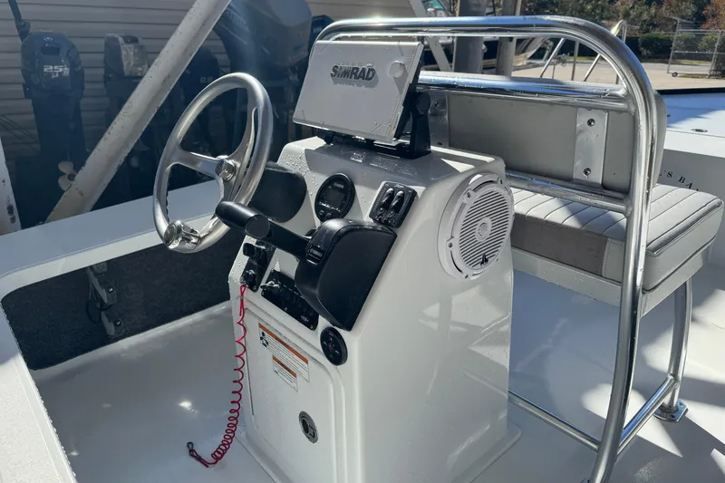 Slide: The Image of 2020 Hell's Bay Marquesa boat console with steering wheel and Simrad display. - 21