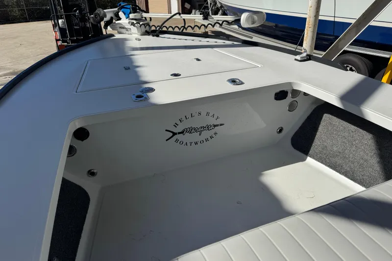 Slide: The Image of 2020 Hell's Bay Marquesa boat interior with logo, featuring storage compartments and clean design. - 7