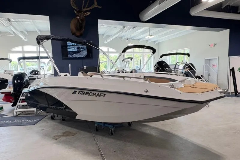 The Image of 2025 Starcraft SVX 171 OB boat displayed in a showroom with modern interior. - 1